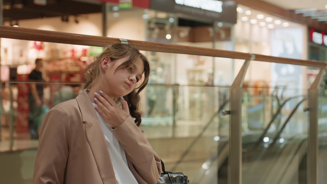 음악을 듣다가 잠시 멈춘 편안한 모습의 젊은 여성, 바쁜 쇼핑 환경 속에서 휴식을 취하는 헤드폰을 낀 여유로운 젊은 여성