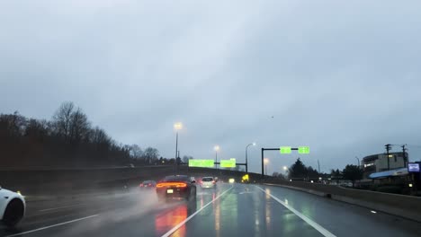 drivin on highway 1 in vancouver, canada during a rainy overcast day with a lot of traffic