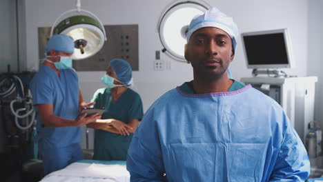 Portrait-Of-Male-Surgeon-Wearing-Scrubs-In-Hospital-Operating-Theater