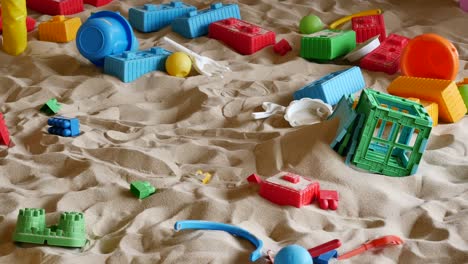 messy toys in a sandpit