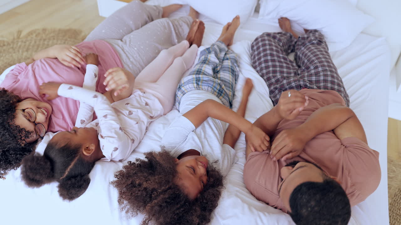 familia, niños y padres en la cama cosquillas para la diversión