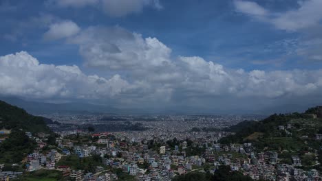 aerial drone footage of kathmandu, nepal’s capital, showcases city life, historic architecture, and scenic skies filled with white clouds—offering a peaceful contrast to the dense urban landscape