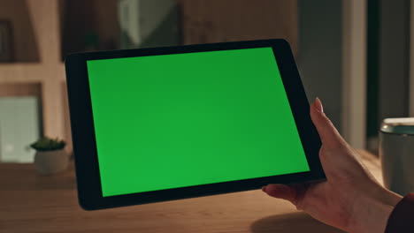 girl hands scrolling chroma key tablet watching social media at home close up.