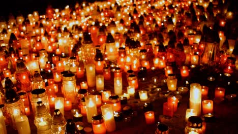 Many-candles-on-the-ground-in-cemetery-during-ceremony