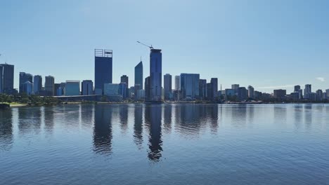 reflection of skyscrapers in the water along the swan river in perth, western australia