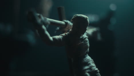 a miniature mummified doll hanging on the gallows at night