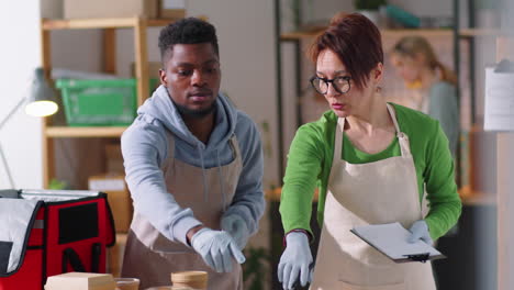 Diverse-Coworkers-Preparing-Meal-for-Delivery-in-Ghost-Kitchen