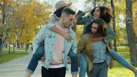 friends having fun piggyback ride in park