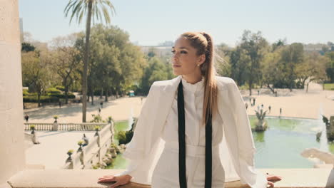 stylish young woman looking away in old park.