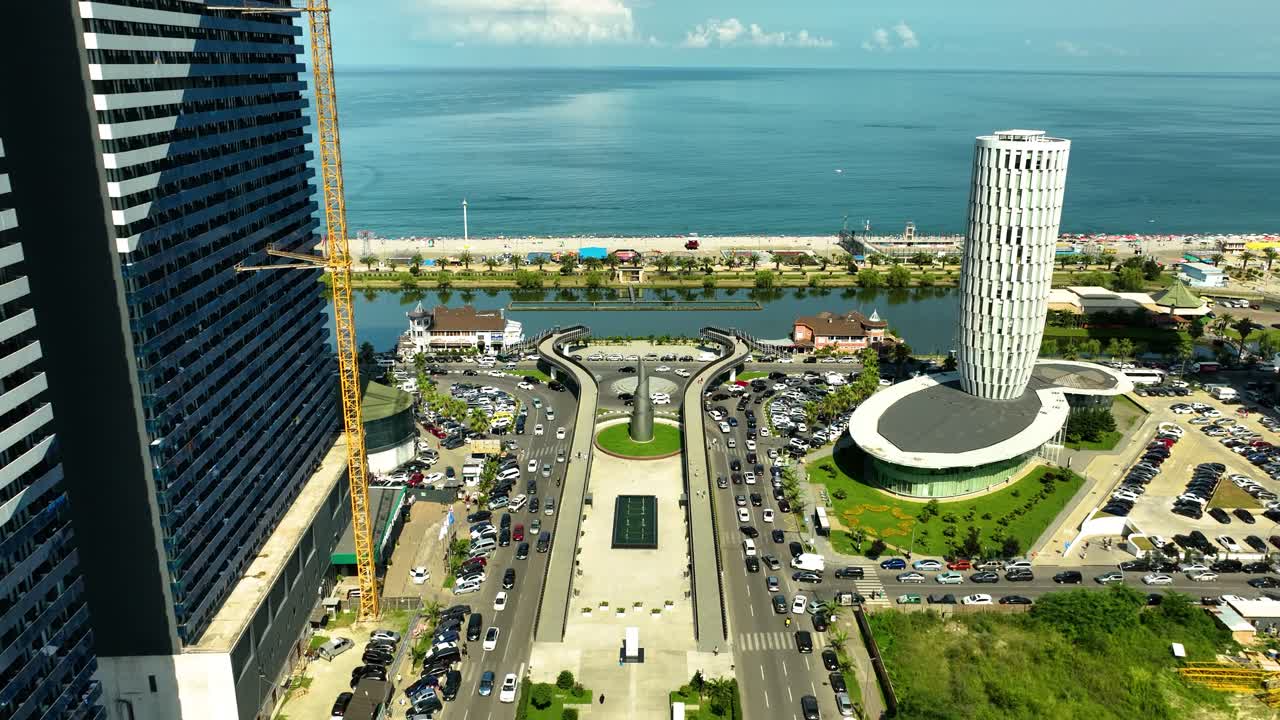 Aerial view of Batumi’s seaside boulevard with modern buildings, traffic, and the Black Sea in the background