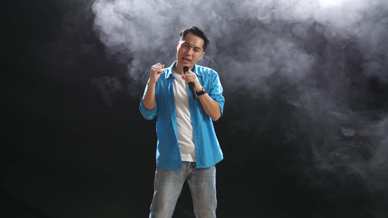 Man Singing with Microphone on Stage