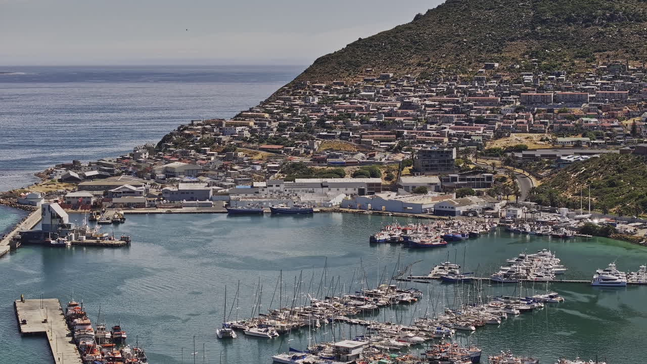 Cape Town South Africa Aerial v91 zoomed flyover Hout Bay Harbor capturing boats docked at the marina, and views of hillside townscape in daytime - Shot with Mavic 3 Pro Cine - Jan 11th 2024