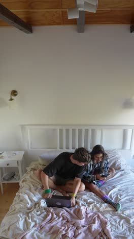 couple using devices in a bedroom