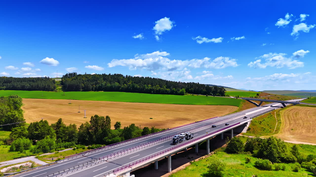 Modern highway and freeway cross the beautiful nature landscape. Picturesque countryside in Slovakia with a road passing by. Aerial view