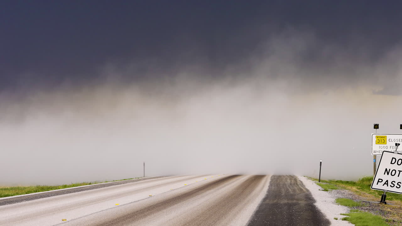 Clouds of dust blowing over a busy highway in stormy weather