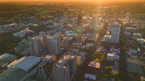Sacramento downtown with high buildings. Amazing city scenery in the orange light of setting sun. Red skies at backdrop.