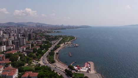 aerial establishing shot above erenkoy public beach on summer day