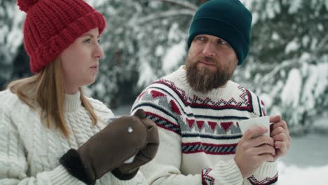 caucasian couple drinking hot tea in winter time.