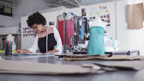 mixed race woman working in fashion office