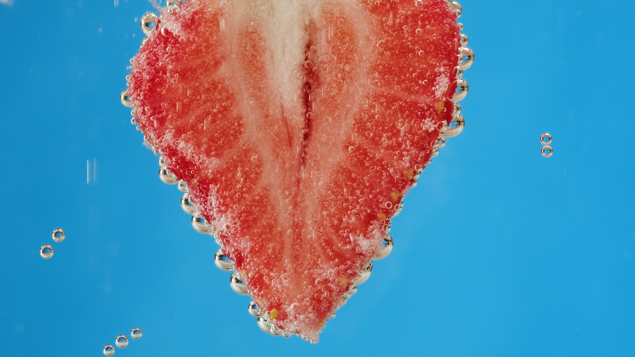 Strawberry Slice in Water with Bubbles