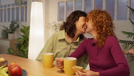 two women sharing a tender moment over breakfast