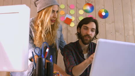 smiling casual designers working over a laptop