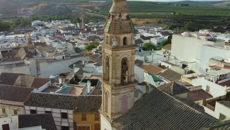 aerial view, iglesia de la concepcion, catholic church bell tower and puente genil, spain cityscape on sunny day, cinematic revealing drone shot