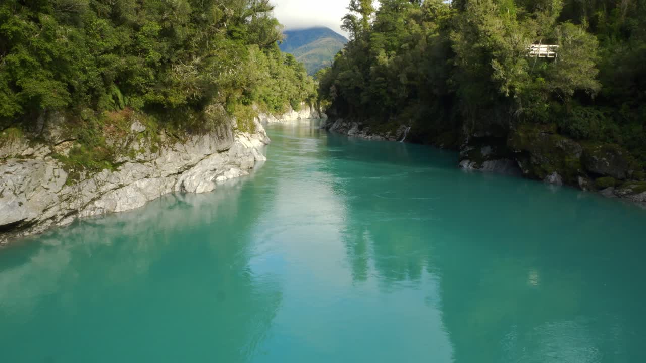 Turquoise And Calm Water Of Hokitika Gorge Surrounded By Dense Forest In West Coast, New Zealand. - tilt up shot