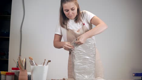 woman sculpting with clay