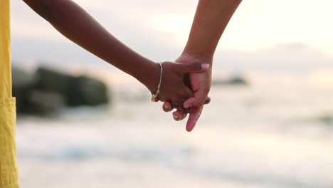 closeup, beach and a couple holding hands