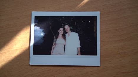 Polaroid-photo-of-a-couple-on-a-wooden-table