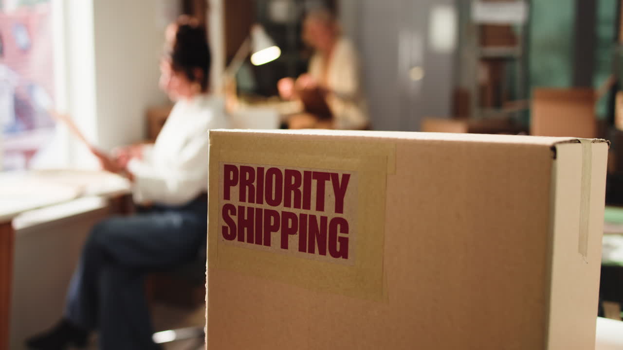 Cardboard Box with Priority Shipping Label in Office