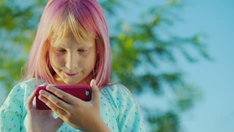 a girl with pink hair is using a pink smartphone