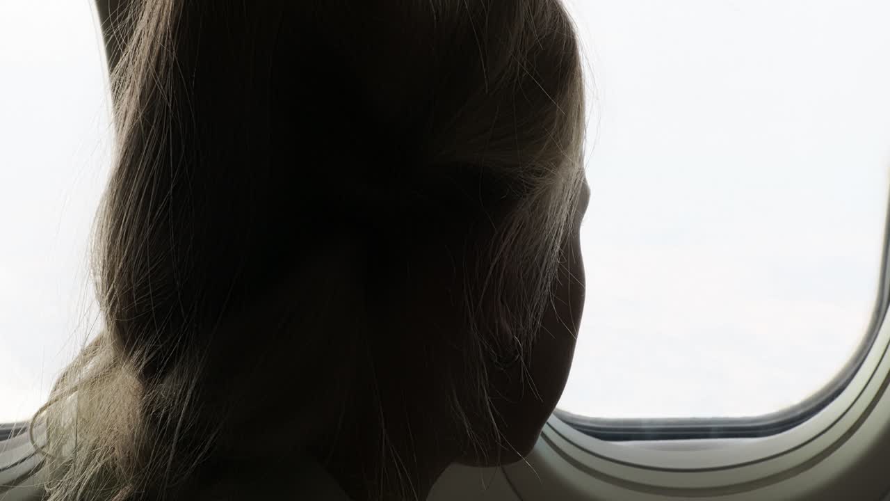 Child Looking Out Airplane Window