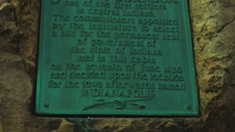 historical marker of john mccormick's cabin site on a granite boulder in indianapolis, indiana, united states