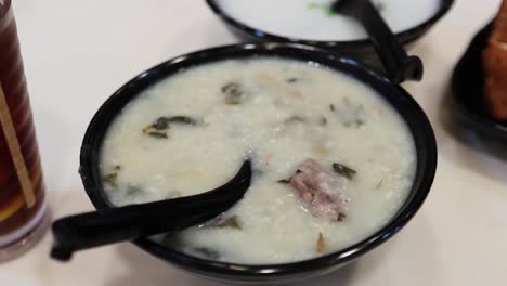 delicious congee served with tea and sides