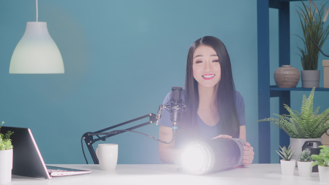 Female blogger recommending studio light accessory on camera