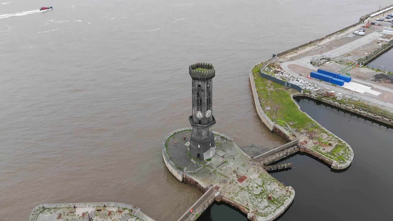 Historic Victoria Tower by the serene riverfront captured from an aerial perspective. Pedestal Down Shot