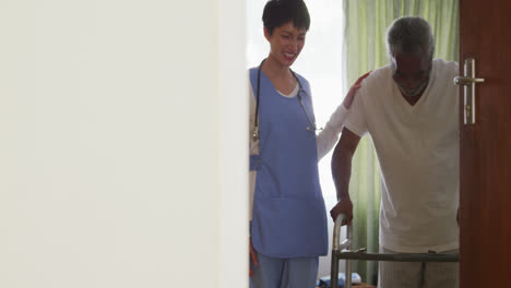 Nurse-helping-a-senior-man-in-retirement-house