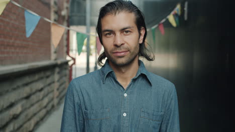 man in denim shirt in urban alley