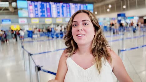 young woman enthusiastically showing boarding pass at airport