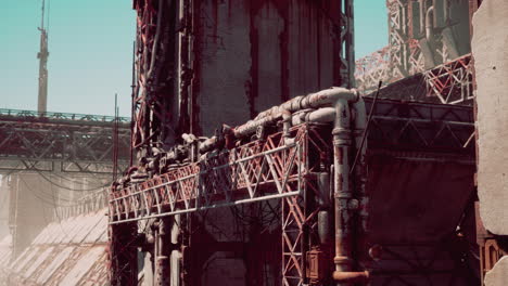 rusty industrial ruins in a desolate landscape