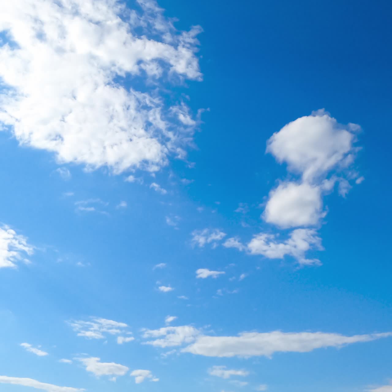 Quick transformation of white soft clouds in the atmosphere. Cumulus cloudscape moving with the wind from low angle perspective. Timelapse