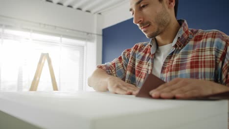 Handheld-video-of-young-man-renovating-old-furniture.