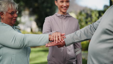 group of people stacking their hands together