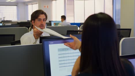 Front-view-of-young-Caucasian-male-executive-giving-documents-to-his-colleague-in-modern-office-4k