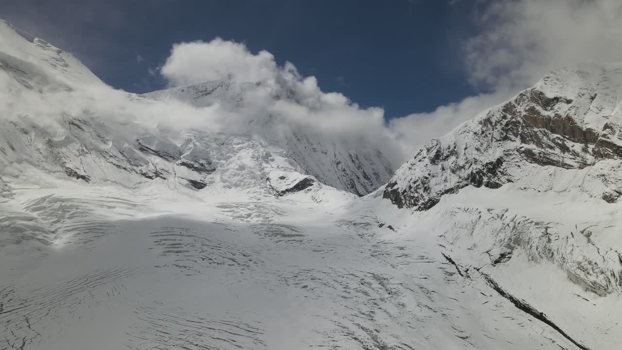 A breathtaking drone view of Manaslu Mountain, rising 8,163 meters in the Nepal Himalaya. The footage captures its towering peaks, dramatic ridges, and pristine high-altitude landscape
