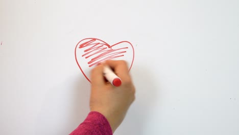 red felt pen draw a heart on paper