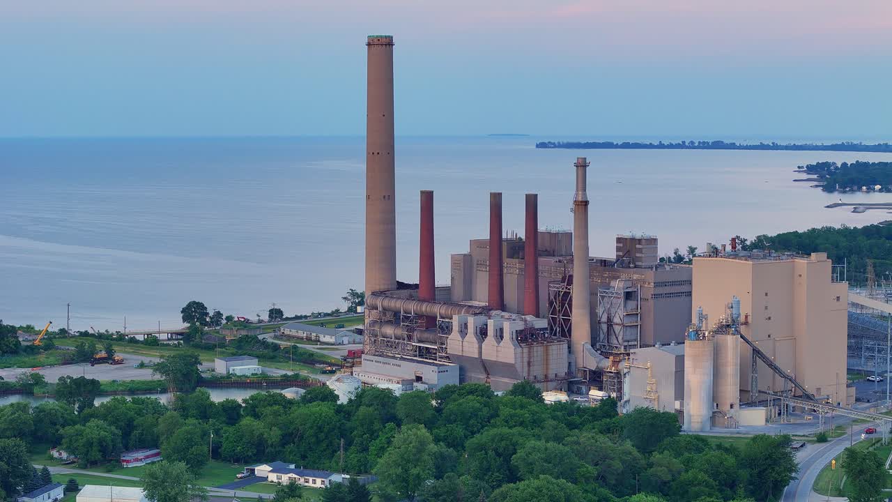Aerial view of Walleye Bay Shore power plant near Lake Erie and wooded coast in Toledo, Ohio