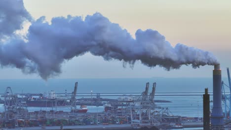 thick grey polluting smog escaping from large industrial plant